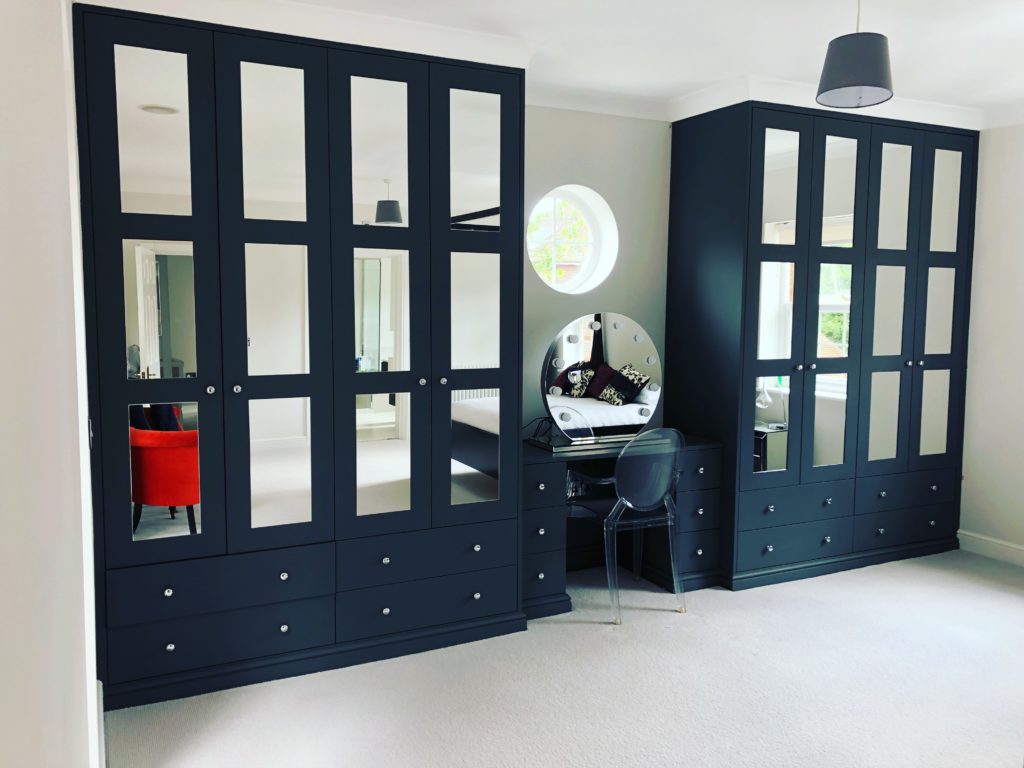 Fitted wardrobes with paneled mirrored doors